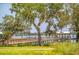 Picturesque waterfront dock with a covered area, grassy lawn, and Spanish moss draped trees in a scenic coastal setting at 200 Bucksley Ln # 302, Charleston, SC 29492