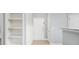 Inviting light-gray entryway with white doors, trim and shelving, offering a clean and organized entrance at 200 Bucksley Ln # 302, Charleston, SC 29492