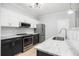 A kitchen featuring stainless appliances, white cabinets, and granite countertops, creating a modern and functional space at 200 Bucksley Ln # 302, Charleston, SC 29492