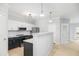 An open-concept kitchen with white cabinets, stainless steel appliances, and a gray countertop, offering a modern design at 200 Bucksley Ln # 302, Charleston, SC 29492