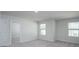 This bedroom features neutral walls, carpet, windows, and an open doorway at 205 W Bradford Pointe Dr, Summerville, SC 29483