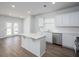 Modern kitchen with white cabinets, quartz countertops, stainless steel appliances, and center island at 205 W Bradford Pointe Dr, Summerville, SC 29483