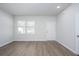 Bright living room featuring wood-look flooring, neutral paint, and ample natural light at 205 W Bradford Pointe Dr, Summerville, SC 29483