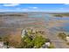 An aerial view shows a waterfront condo community with long boardwalks over marshlands under a sunny sky at 2105 Landfall Way, Seabrook Island, SC 29455