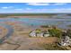 Beautiful aerial of waterfront condos with scenic marsh views and boardwalks under a clear blue sky at 2105 Landfall Way, Seabrook Island, SC 29455