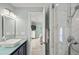 Bathroom featuring a modern vanity, a glass shower with marble tiling, and an adjacent bedroom at 2105 Landfall Way, Seabrook Island, SC 29455