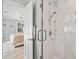 Bright bathroom with a glass shower stall with marble tile and view into a bedroom at 2105 Landfall Way, Seabrook Island, SC 29455