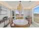Bright dining area with marsh views and modern chandelier at 2105 Landfall Way, Seabrook Island, SC 29455