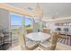Bright dining area with marsh views and modern chandelier at 2105 Landfall Way, Seabrook Island, SC 29455