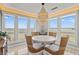 Bright dining area with marsh views and modern chandelier at 2105 Landfall Way, Seabrook Island, SC 29455