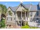 Attractive home with large balconies, featuring palm trees, shutters, and an outdoor staircase at 2105 Landfall Way, Seabrook Island, SC 29455