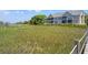Exterior shot of a condo featuring screened porches, set amongst lush marsh grasses, offering serene outdoor living spaces at 2105 Landfall Way, Seabrook Island, SC 29455