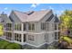 Exterior angle of a condo building with screened porches, offering views of the surrounding trees and landscaping at 2105 Landfall Way, Seabrook Island, SC 29455