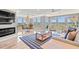 Bright living room with large windows, fireplace, hardwood floors and stylish decor at 2105 Landfall Way, Seabrook Island, SC 29455