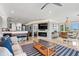 Open living space featuring a fireplace, TV, dining area, and partial kitchen view at 2105 Landfall Way, Seabrook Island, SC 29455