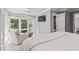 Relax in this bright primary bedroom with a large window, comfy chair, and TV at 2105 Landfall Way, Seabrook Island, SC 29455