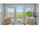 A cozy sitting area offers stunning views of the marsh through large windows at 2105 Landfall Way, Seabrook Island, SC 29455