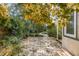 Secluded backyard brick patio featuring lush landscaping and mature shade trees at 2137 Wappoo Dr, Charleston, SC 29412