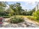 Lush backyard showcasing stone pathway and verdant landscaping at 2137 Wappoo Dr, Charleston, SC 29412