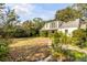 Large backyard with mature trees and a well-manicured lawn at 2137 Wappoo Dr, Charleston, SC 29412