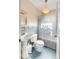Vintage bathroom featuring a pedestal sink, blue tile accents, and a patterned shower curtain at 2137 Wappoo Dr, Charleston, SC 29412