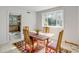 Cozy dining room features a wooden table, woven chairs, a colorful rug, and a large window with lots of light at 2137 Wappoo Dr, Charleston, SC 29412