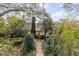 Lovely home featuring a brick pathway, mature trees, and verdant landscaping at 2137 Wappoo Dr, Charleston, SC 29412