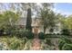 Charming home with lush landscaping, brick path, and a vine-covered chimney, creating a welcoming curb appeal at 2137 Wappoo Dr, Charleston, SC 29412