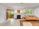 Comfortable living room featuring a fireplace, a door, and large windows, and tile floors at 2137 Wappoo Dr, Charleston, SC 29412