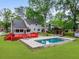 Aerial view of a large backyard, swimming pool and red deck with patio furniture at 22 Monte Sano Dr, Hanahan, SC 29410