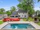 Backyard featuring a large in-ground pool, deck, and well-maintained lawn at 22 Monte Sano Dr, Hanahan, SC 29410