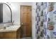 A bathroom featuring a wood door, a shower with a curtain, and a vanity at 22 Monte Sano Dr, Hanahan, SC 29410