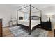 Bright bedroom featuring a four-poster bed, stylish rug, and lots of natural light from the window at 22 Monte Sano Dr, Hanahan, SC 29410