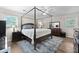 A spacious bedroom featuring a four-poster bed, wood floors, and neutral tones for a relaxing ambiance at 22 Monte Sano Dr, Hanahan, SC 29410
