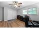Bedroom featuring hardwood floors, closet, two windows, and a ceiling fan at 22 Monte Sano Dr, Hanahan, SC 29410