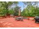 Outdoor dining set on a spacious deck surrounded by mature trees and lush greenery at 22 Monte Sano Dr, Hanahan, SC 29410