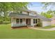 Charming home with mature landscaping, a covered porch, and a manicured lawn at 22 Monte Sano Dr, Hanahan, SC 29410