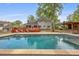 Relaxing backyard featuring a sparkling pool, spacious deck, and lush landscaping at 22 Monte Sano Dr, Hanahan, SC 29410