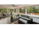 Bright sunroom with large windows, ceiling fan, and comfortable seating area at 22 Monte Sano Dr, Hanahan, SC 29410