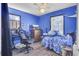 Cozy bedroom featuring blue walls, wood-look flooring, and a ceiling fan at 225 Arbor Rd, Summerville, SC 29485