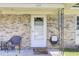 Inviting front porch featuring a white door and brick facade for a warm, welcoming entrance at 225 Arbor Rd, Summerville, SC 29485