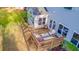 Aerial view of a wood backyard deck with patio furniture overlooking a lush green lawn and manicured landscape at 2524 Deer Walk Way, Mount Pleasant, SC 29466