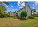 Spacious backyard featuring a well-maintained lawn, mature trees, and a wooden deck with stairs at 2524 Deer Walk Way, Mount Pleasant, SC 29466
