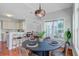 Open-concept breakfast nook featuring hardwood floors, modern lighting, and bar-stool seating at 2524 Deer Walk Way, Mount Pleasant, SC 29466