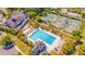 Aerial view of a community pool, tennis courts, and clubhouse surrounded by mature trees and landscaping at 2524 Deer Walk Way, Mount Pleasant, SC 29466