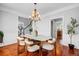 Open concept dining room featuring a modern table, chairs, and a view of the staircase and kitchen at 2524 Deer Walk Way, Mount Pleasant, SC 29466