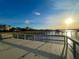 Stunning dock view at sunset, with a picturesque pier and waterfront homes under a bright, sunny sky at 2524 Deer Walk Way, Mount Pleasant, SC 29466