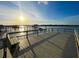 Waterfront view from a wooden dock overlooking calm waters, and nearby covered pier at 2524 Deer Walk Way, Mount Pleasant, SC 29466