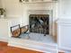Elegant fireplace with a marble surround, decorative screen, and a convenient log holder, adding warmth and charm at 2524 Deer Walk Way, Mount Pleasant, SC 29466