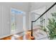 Bright foyer featuring hardwood floors, a staircase, and a front door with sidelights and transom windows at 2524 Deer Walk Way, Mount Pleasant, SC 29466